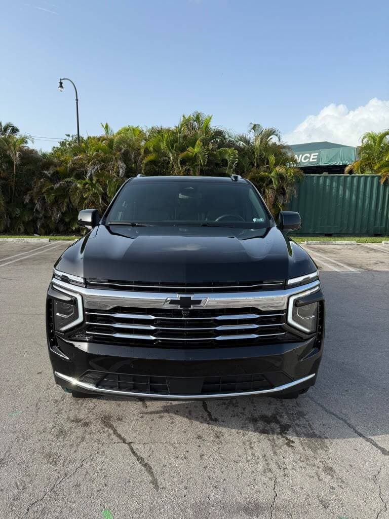 Front view of a black Chevrolet Suburban used for black car service in Miami